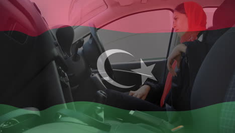 in car, woman looking contemplative with libyan flag animation overlay