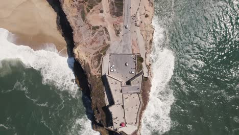 aerial top down reverse over nazaré or nazare lighthouse, portugal