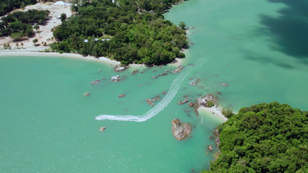 Cảnh quay drone sống động ghi lại cảnh một chiếc mô tô nước lướt qua làn nước màu ngọc lam và các eo biển đảo đá tại quần đảo Langkawi tuyệt đẹp, Malaysia