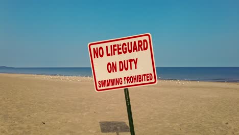 Slow-push-on-a-No-Life-Guard-sign-on-a-beach-in-New-York-Lake-Ontario