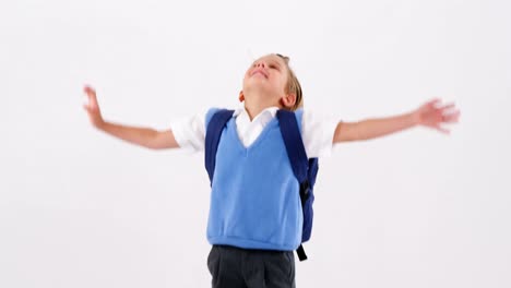 Smiling-schoolboy-having-fun-against-white-background