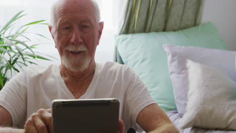 senior man in social distancing using digital tablet