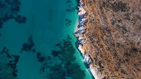 Azure-Majesty-of-Deep-Sea-and-Rocky-Shore-Showcase-Nature's-Palette-with-Amazing-Colors-of-Orange-and-Teal-in-Lukova