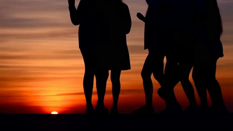 silhouetted people at sunset