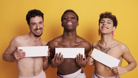 Trans men posing flirtatiously covering their breasts with a panel