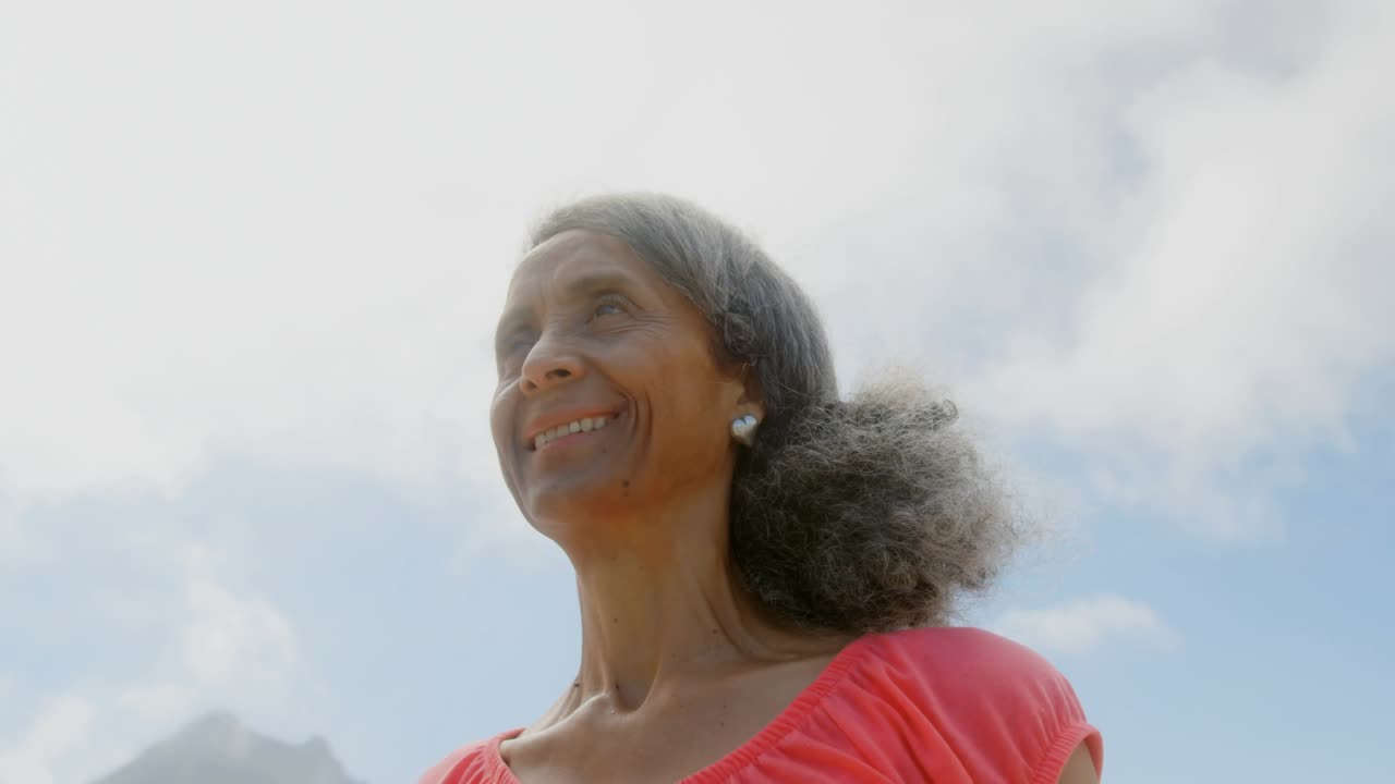 Woman smiling and looking up causing social media likes and hearts piling near head growing fans