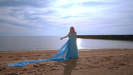 pregnancy fashion. pregnant model in blue dress on beach. woman pregnant