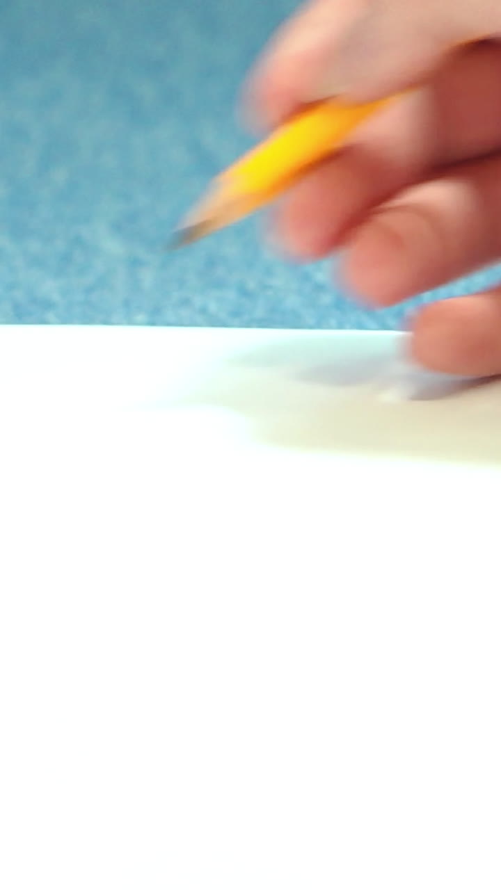 Girl doing pencil sketches on paper. Young woman learns to draw. Vertical video
