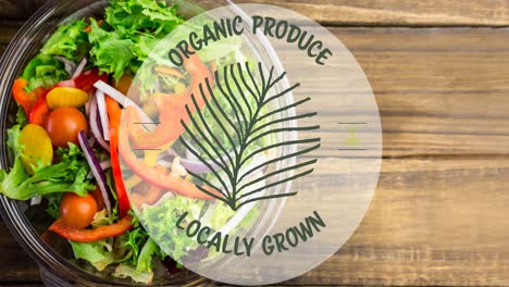 animation of locally grown organic produce text in green, over bowl of fresh salad on wooden boards