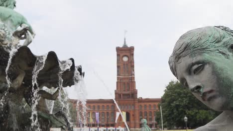 the neptune fountain in front of rotes rathaus building in berlin