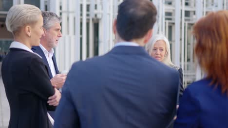 group of business professionals having an outdoor meeting