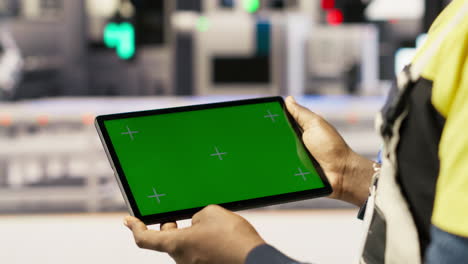 smart factory expert uses green screen tablet to implement automated workflows