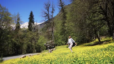 woman hiking in a spring mountain flower field