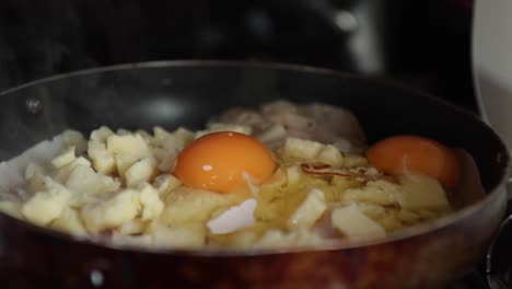 closed frame of a frying pan while a man adds it an egg