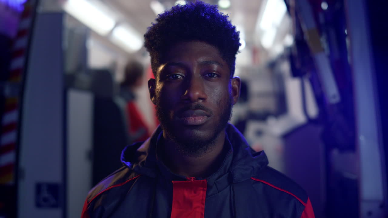 아프리카계 미국인 남자가 밤에 거리에서 서 있습니다.