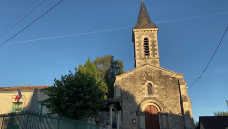 church in france with maire’s office next door with blue sky behind