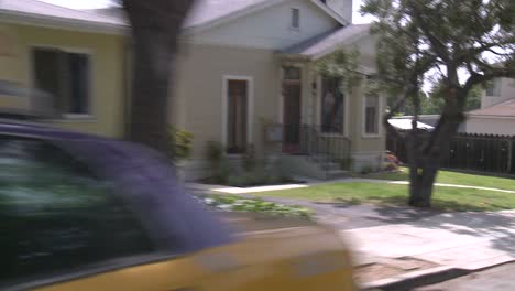 a car travels along a street in santa monica california as seen through the rear window at an angle 8