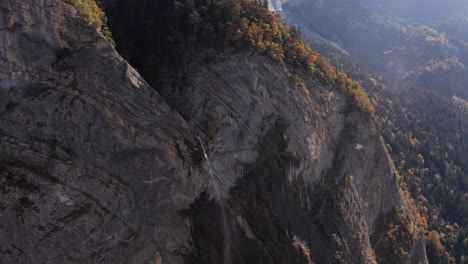 aerial of small waterfall on mountain ridge