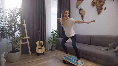 woman on deck for balance stands with her feet, pretending she is surfing