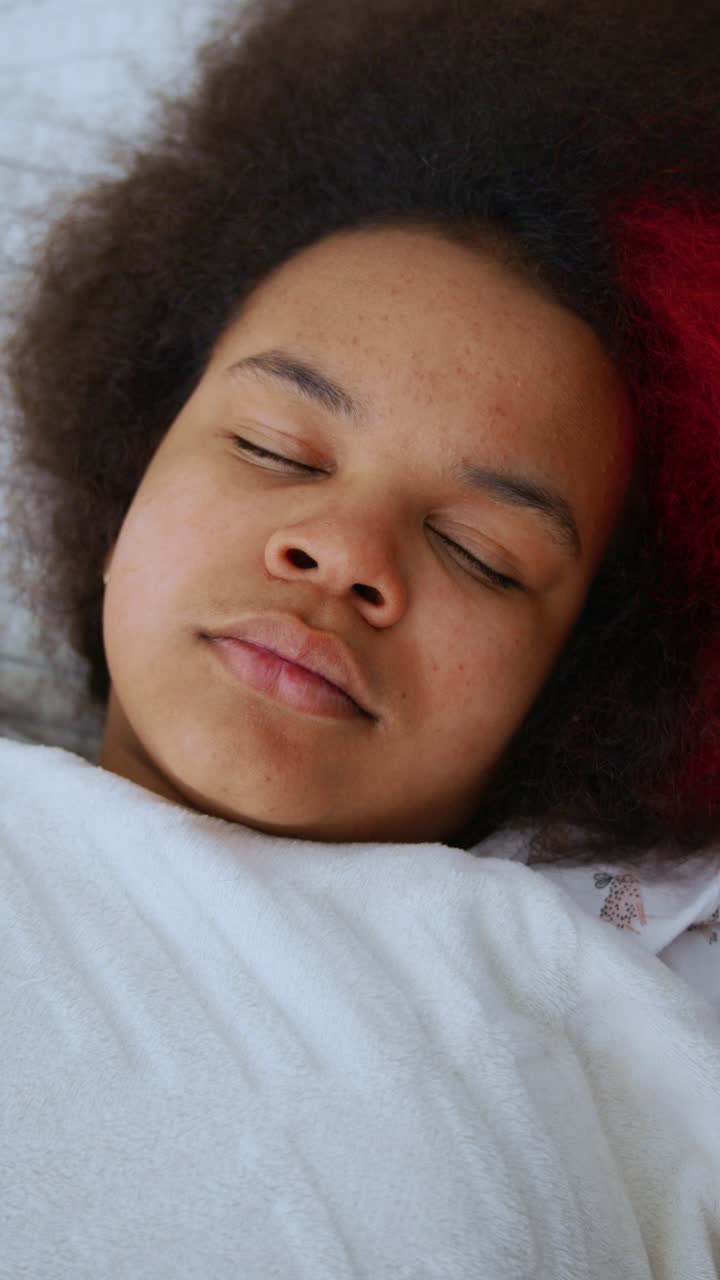 Nærbillede af ung person, der sover tungt i sengen
