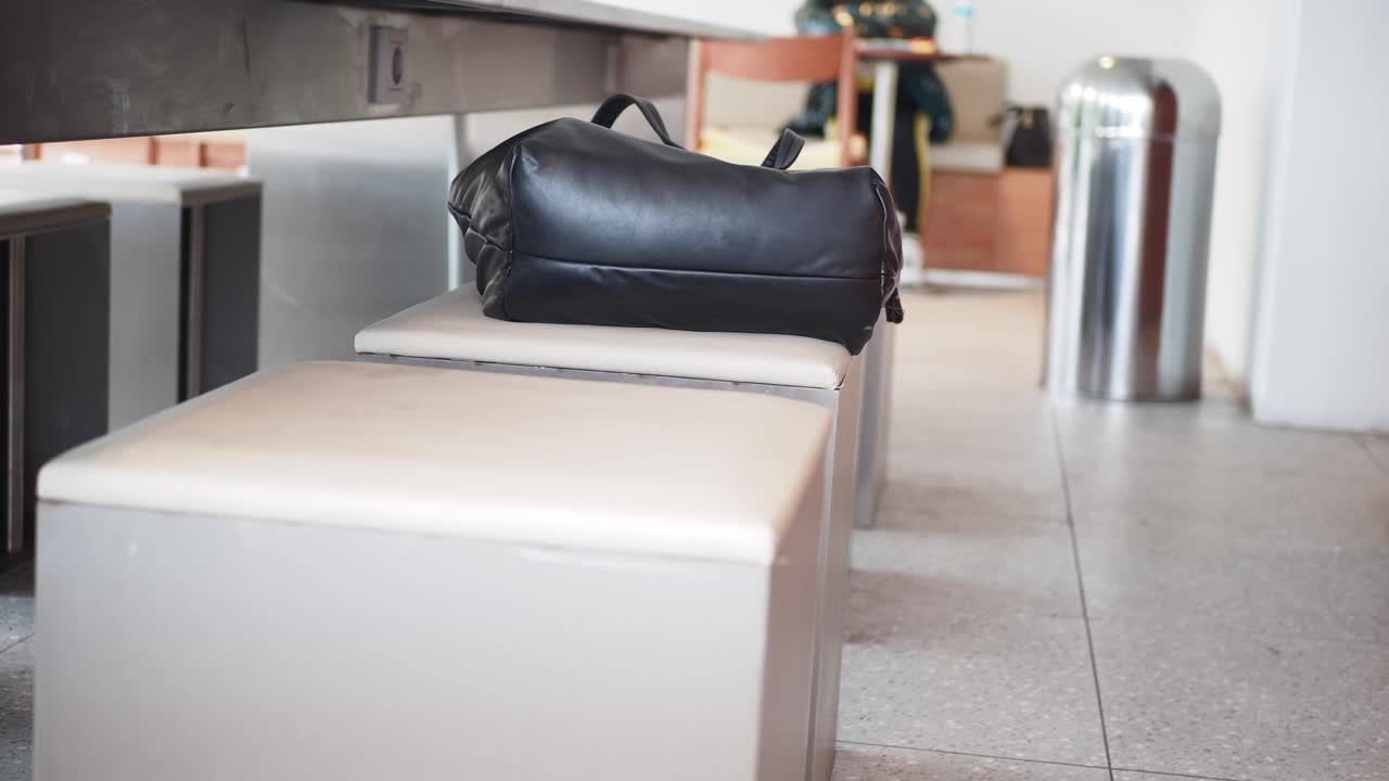 Black Bag Resting on a Stool in a Public Interior