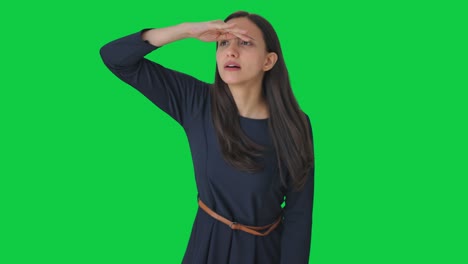 curious indian girl searching someone green screen