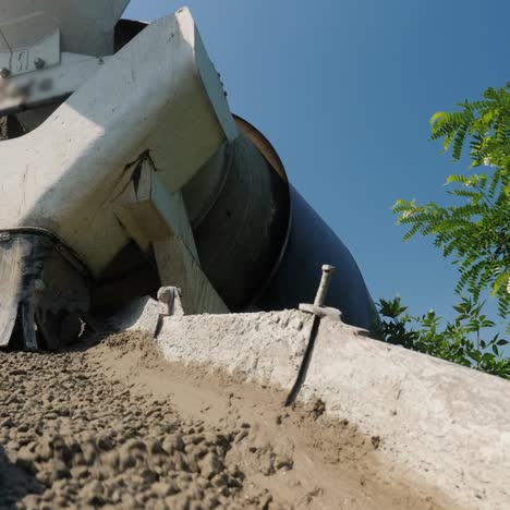 concrete flows from the concrete mixer through a trough