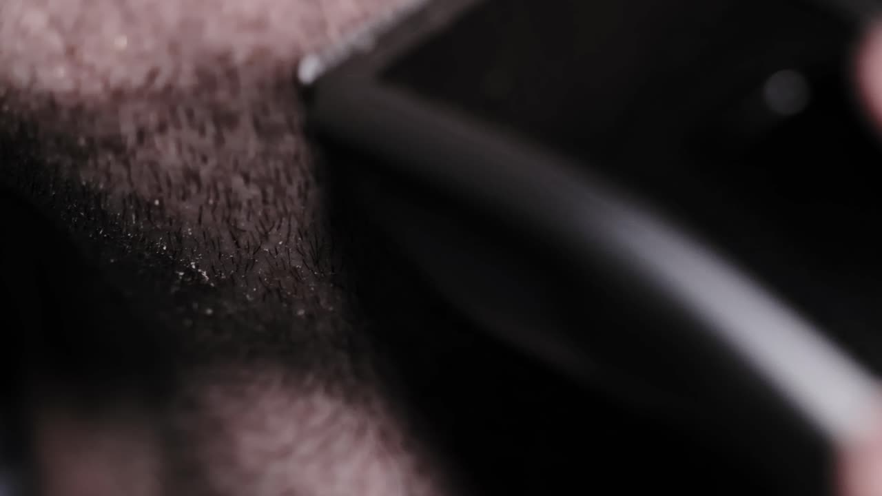 Dull razor scrapes neck stubble pulling skin debris in intense slow motion