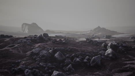 stones in snow on moutain in summer
