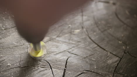 close-up of drilling hole in wood log