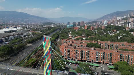 Aerial-orbits-cable-tower-of-multi-lane-bridge-in-Medellin,-Colombia