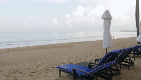 luxury beach lounge beds with umbrella on white sand beach