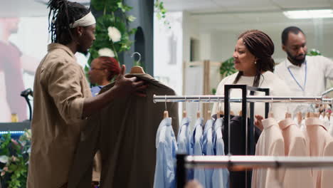 Shopper-picking-between-clothes-in-store