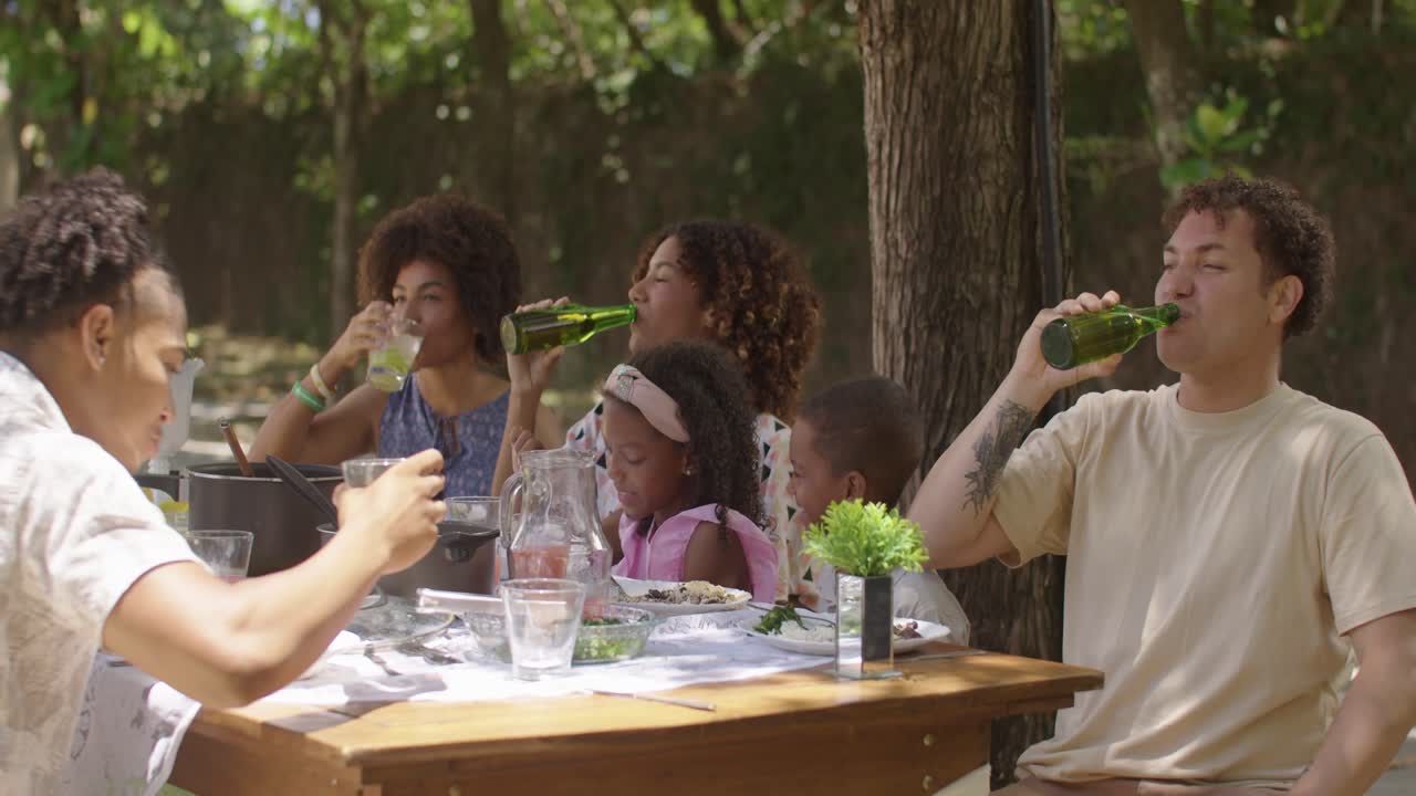 Family and Friends Enjoying an Outdoor Meal Together