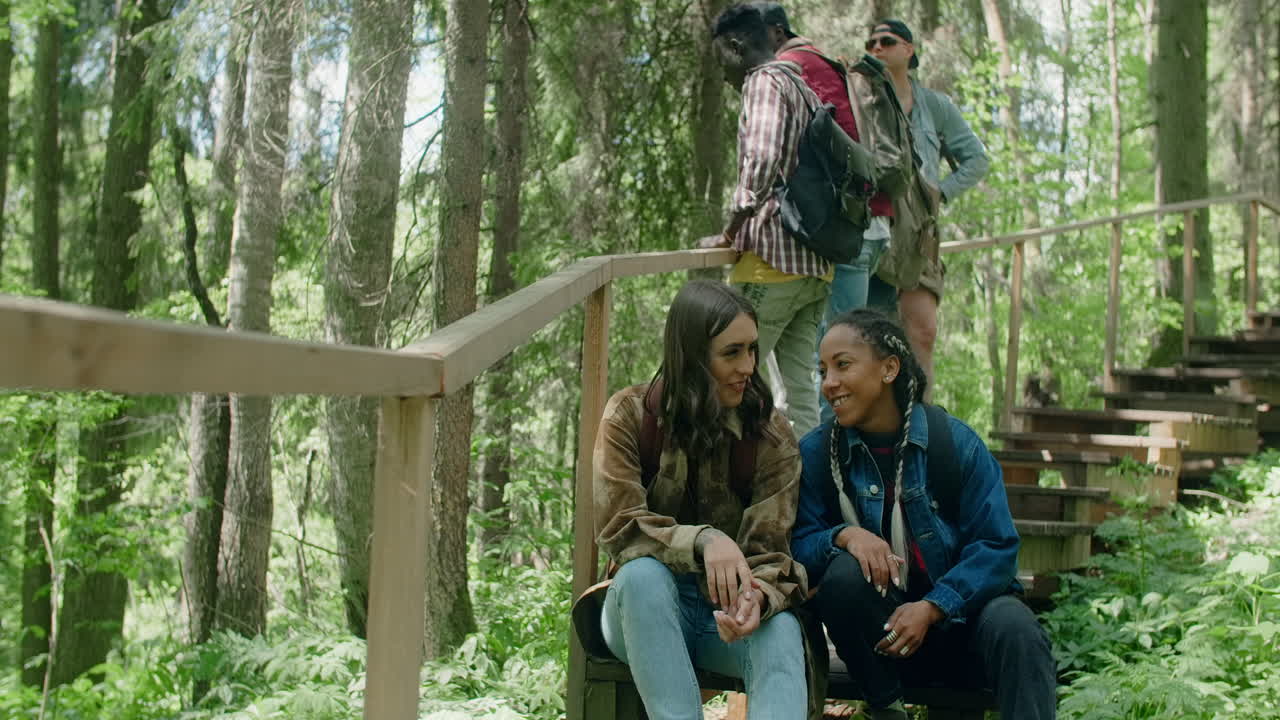 Friends Talking on Hiking Trail in Forest