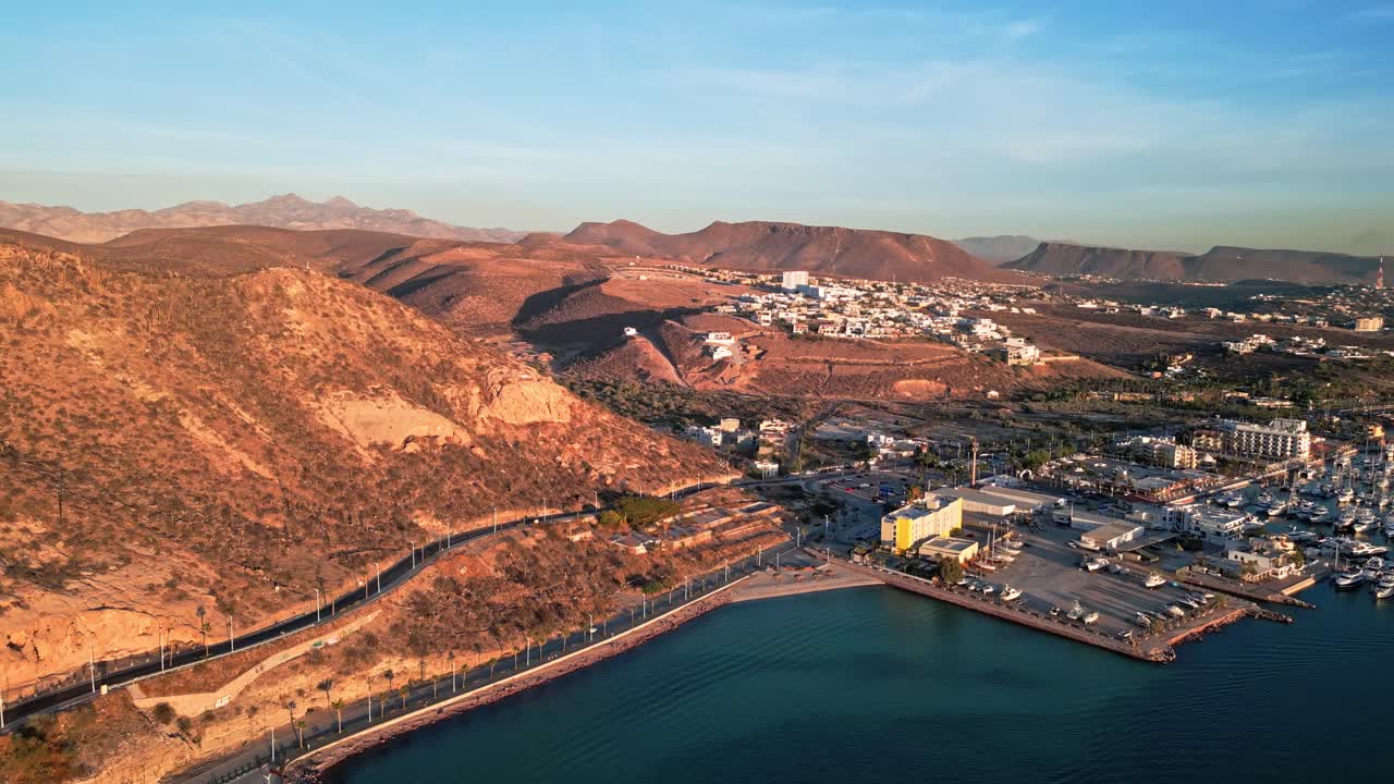 Peaceful coastal marina with desert hills, La Paz Malecon Calavera, golden sunset light