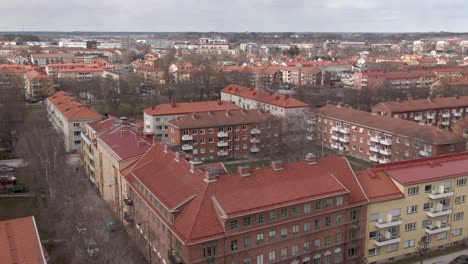 drone shot flying over uppsala city in sweden with houses and apartments