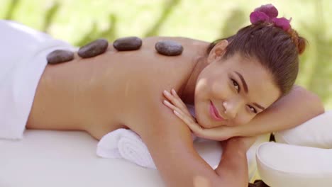 pretty young woman having a hot stone massage