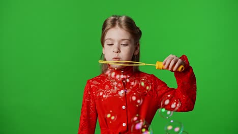 smiling girl blowing in soap bubble stick maker bubbles flying around positive expression isolated children emotions advertisement concept smiling girl blowing in soap bubble stick maker bubbles flying around positive expression isolated on chroma key green screen studio background mockup
