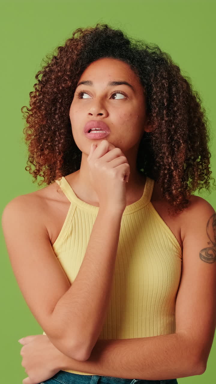 Young Woman with Curly Hair Thinking and Pondering on Green Screen