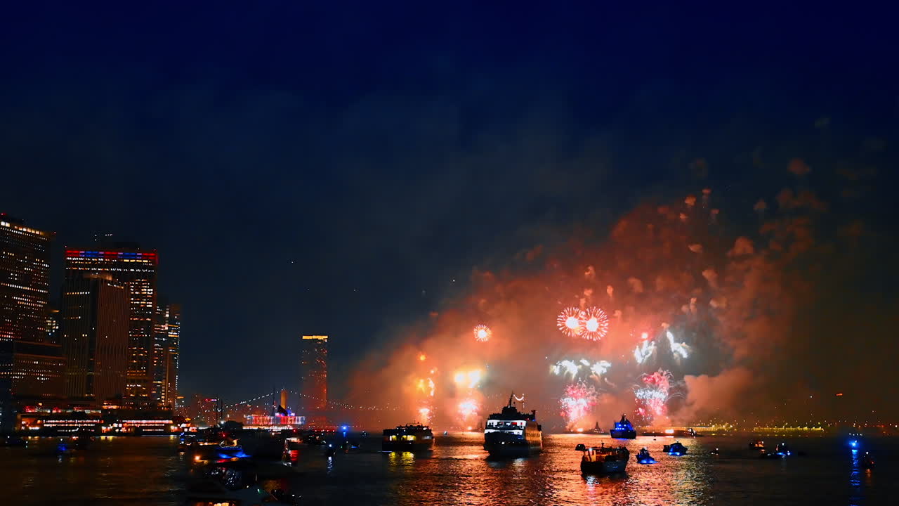 Fantastic firework over the East River in New York, USA. Lots of boats are on the waterscape watching the show