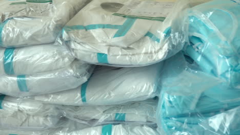 new packed medical suits lie stacked up in a protective bag