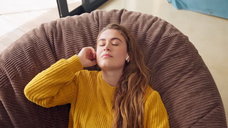 woman relaxing on beanbag with headphones