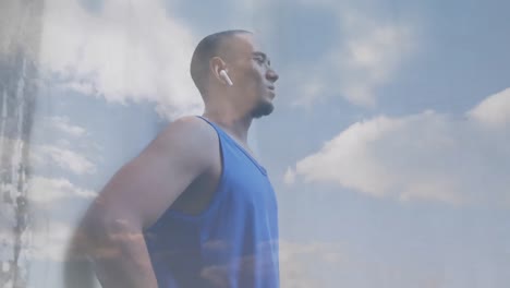 animación de nubes sobre atleta masculino usando auriculares inalámbricos y reloj inteligente haciendo ejercicio al aire libre