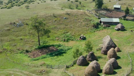 Aerial:-arc-shot-of-old-farm-buildings,-remote-Serbian-hillside