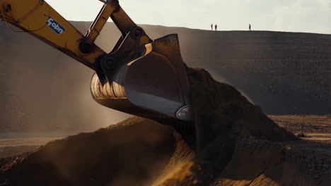 excavator at work with people in background