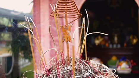 burning incense sticks in a buddhist temple at tam coc, vietnam