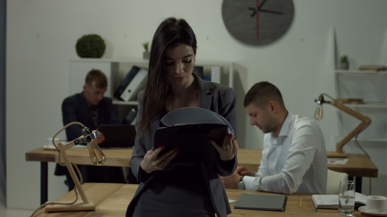 Mujer de negocios leyendo documentos en una carpeta