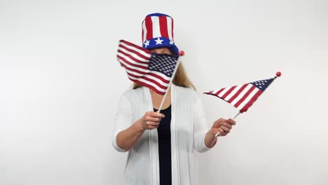 a redhaired woman is seen swaying two flags in front of her in slow motion