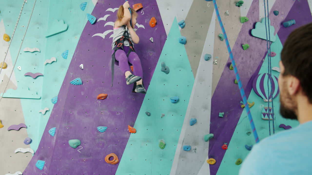 Girl Rock Climbing with Instructor